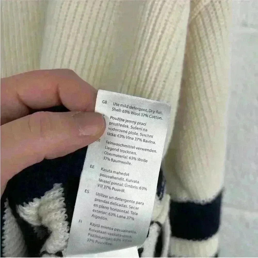 COS Roll neck sweater in white and black striped wool and cotton blend